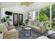 Relaxing sunroom featuring wicker furniture, potted plants, and access to the outdoors at 606 Vega Nw St, Concord, NC 28027