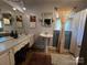 Well-lit bathroom with pedestal sink, vanity, and classic fixtures at 6109 Cora St, Charlotte, NC 28216