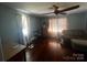Bedroom featuring wood floors, windows, and a ceiling fan at 6109 Cora St, Charlotte, NC 28216