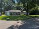 Beautiful home featuring lush landscaping, mature trees and vibrant curb appeal at 6109 Cora St, Charlotte, NC 28216