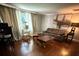 Inviting living room featuring a leather sofa, wood floors, and neutral walls at 6109 Cora St, Charlotte, NC 28216