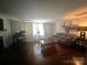 Inviting living room featuring a leather sofa, wood floors, and neutral walls at 6109 Cora St, Charlotte, NC 28216