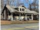 Damaged two-story home with covered front porch and visible fire damage at 619 N Main St, Landis, NC 28088