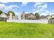 Backyard view of the home featuring a green lawn and privacy fence at 6619 Bittinger Ct, Charlotte, NC 28216