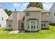 Back exterior view showcasing the home's backyard, patio, and lush green lawn at 6619 Bittinger Ct, Charlotte, NC 28216
