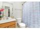 Compact bathroom with a shower/tub combo and oak vanity with sink at 6619 Bittinger Ct, Charlotte, NC 28216
