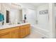 Bright bathroom with double vanity, soaking tub, and natural light from glass block window at 6619 Bittinger Ct, Charlotte, NC 28216