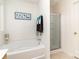 Bright bathroom showcasing a soaking tub with shower head and glass enclosed shower at 6619 Bittinger Ct, Charlotte, NC 28216