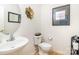 Quaint half bathroom featuring a pedestal sink and decorative wall art at 6619 Bittinger Ct, Charlotte, NC 28216