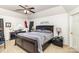 Spacious bedroom featuring a ceiling fan, dark furniture, and neutral carpet at 6619 Bittinger Ct, Charlotte, NC 28216