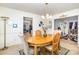 Bright dining room with a wooden table, neutral chairs, and elegant lighting fixture for Gathering meals at 6619 Bittinger Ct, Charlotte, NC 28216