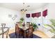 Stylish dining area featuring a dark wood table, matching chairs, and ample natural light from nearby windows at 6619 Bittinger Ct, Charlotte, NC 28216