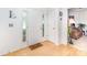 Bright entryway featuring hardwood floors, white walls, and a welcoming front door with sidelights at 6619 Bittinger Ct, Charlotte, NC 28216