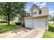 Two-story home boasts a two-car garage, well-maintained lawn, and neutral siding under a cloudy sky at 6619 Bittinger Ct, Charlotte, NC 28216
