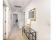 Light-filled hallway with a glass-topped table and access to multiple rooms at 6619 Bittinger Ct, Charlotte, NC 28216