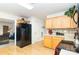 Functional kitchen with wooden cabinets, stainless steel refrigerator, and easy access to the adjacent living area at 6619 Bittinger Ct, Charlotte, NC 28216