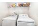 Bright laundry room featuring a side by side washer and dryer and storage shelf at 6619 Bittinger Ct, Charlotte, NC 28216