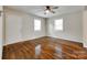 Bright bedroom featuring hardwood floors, a ceiling fan, and natural light from two windows at 814 Grace St, Kings Mountain, NC 28086