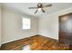 Bedroom with hardwood floors, neutral walls, and a ceiling fan; window allows natural light at 814 Grace St, Kings Mountain, NC 28086