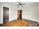 Bedroom with hardwood floors, ceiling fan, and wood-paneled interior doors at 814 Grace St, Kings Mountain, NC 28086