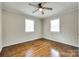 Inviting bedroom featuring hardwood floors, two windows, and a ceiling fan with light at 814 Grace St, Kings Mountain, NC 28086