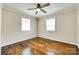 Bright bedroom features hardwood floors, neutral walls, two windows, and a ceiling fan at 814 Grace St, Kings Mountain, NC 28086