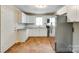 Well-lit kitchen with white cabinets, stainless steel appliances, and terracotta tile flooring at 814 Grace St, Kings Mountain, NC 28086