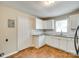 Bright kitchen featuring white cabinets, granite countertops, and terracotta tile flooring at 814 Grace St, Kings Mountain, NC 28086