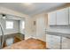 Open kitchen with white cabinets, granite countertops, and terracotta tile flooring, plus hardwood floors beyond at 814 Grace St, Kings Mountain, NC 28086