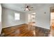 Bright living room with beautiful hardwood floors, a ceiling fan, and an open view to the adjacent rooms at 814 Grace St, Kings Mountain, NC 28086