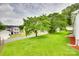 Exterior view showing landscaped yard, mature trees, and a glimpse of the two-story home at 814 Grace St, Kings Mountain, NC 28086