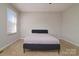 Minimalist bedroom with a large bed, neutral walls, carpeted floor, and ample natural light at 825 21St Ne Ave, Hickory, NC 28601