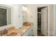 Elegant bathroom with double sink vanity featuring granite countertop and tiled shower through an open door at 828 Saint Andrews Pl, Concord, NC 28025