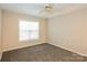 Cozy bedroom with soft carpeting, a bright window, and neutral walls, creating a calming retreat at 828 Saint Andrews Pl, Concord, NC 28025