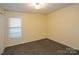 Comfortable bedroom featuring plush carpeting, a bright window, and neutral walls, creating a calming retreat at 828 Saint Andrews Pl, Concord, NC 28025