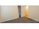 Comfortable bedroom featuring plush carpeting with closet and door, offering a functional and inviting space at 828 Saint Andrews Pl, Concord, NC 28025