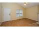 Inviting living room features bright neutral walls, wood floors, and a large window for natural light at 828 Saint Andrews Pl, Concord, NC 28025