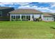 Spacious backyard featuring well-maintained green grass, flower pots, a covered grill and lots of open space at 8516 Profit Ln, Charlotte, NC 28215