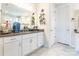 Bright bathroom featuring white cabinets, gray countertops, and stylish marble flooring for a clean and modern aesthetic at 8516 Profit Ln, Charlotte, NC 28215