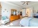 Bright bedroom features a ceiling fan, tray ceiling, and large windows with natural light at 8516 Profit Ln, Charlotte, NC 28215