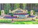 A beautiful stone community entrance sign with tiered landscaping and a decorative waterfall feature at 8516 Profit Ln, Charlotte, NC 28215