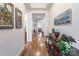 Elegant hallway featuring hardwood floors, decorative artwork, and a view into the home's living spaces at 8516 Profit Ln, Charlotte, NC 28215
