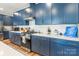 Contemporary kitchen equipped with stainless steel appliances, white countertops, and modern blue cabinets at 8516 Profit Ln, Charlotte, NC 28215