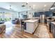 Open-concept kitchen featuring an island, stainless steel appliances, and seamless flow into the living area at 8516 Profit Ln, Charlotte, NC 28215