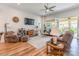 Bright living room with wood floors, ceiling fan, and access to a screened porch at 8516 Profit Ln, Charlotte, NC 28215