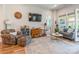 Bright living room with wood floors, ceiling fan, and access to a screened porch at 8516 Profit Ln, Charlotte, NC 28215