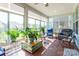 Bright sunroom with hardwood floors, lots of windows, and comfortable seating, creating a serene retreat filled with sunlight at 8516 Profit Ln, Charlotte, NC 28215