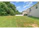 Spacious backyard featuring lush green grass and mature trees at 9807 Maywine Cir, Huntersville, NC 28078