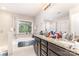 Bright bathroom featuring double vanity with granite countertop, soaking tub and glass shower at 9807 Maywine Cir, Huntersville, NC 28078