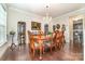 Traditional dining room featuring a wooden table, chandelier, and display cabinets at 9807 Maywine Cir, Huntersville, NC 28078